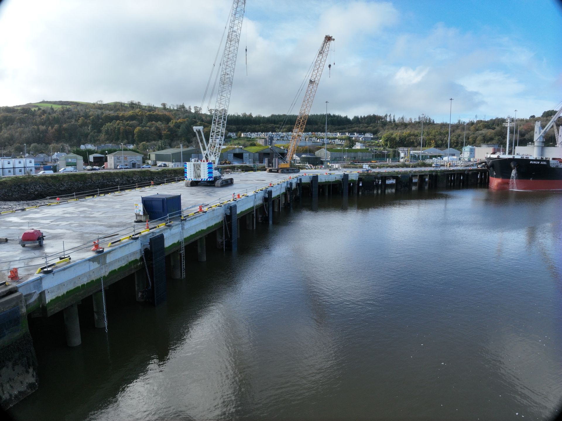 A large body of water with a dock in the foreground