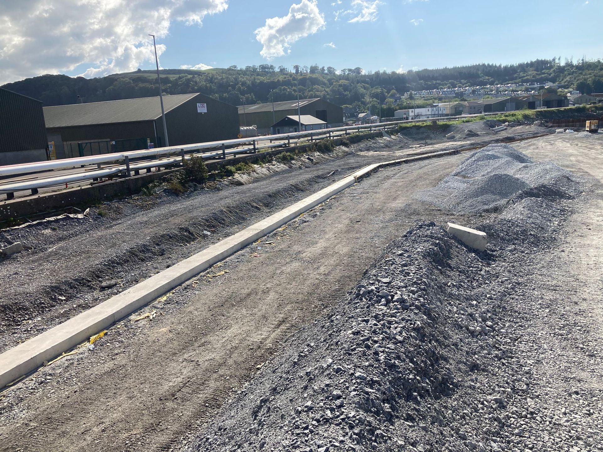 A pile of gravel is on the side of a road