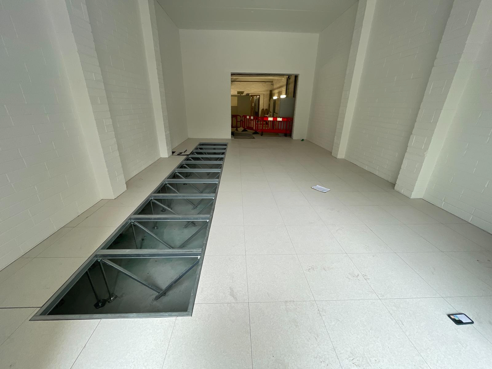 An empty room with a few holes in the floor