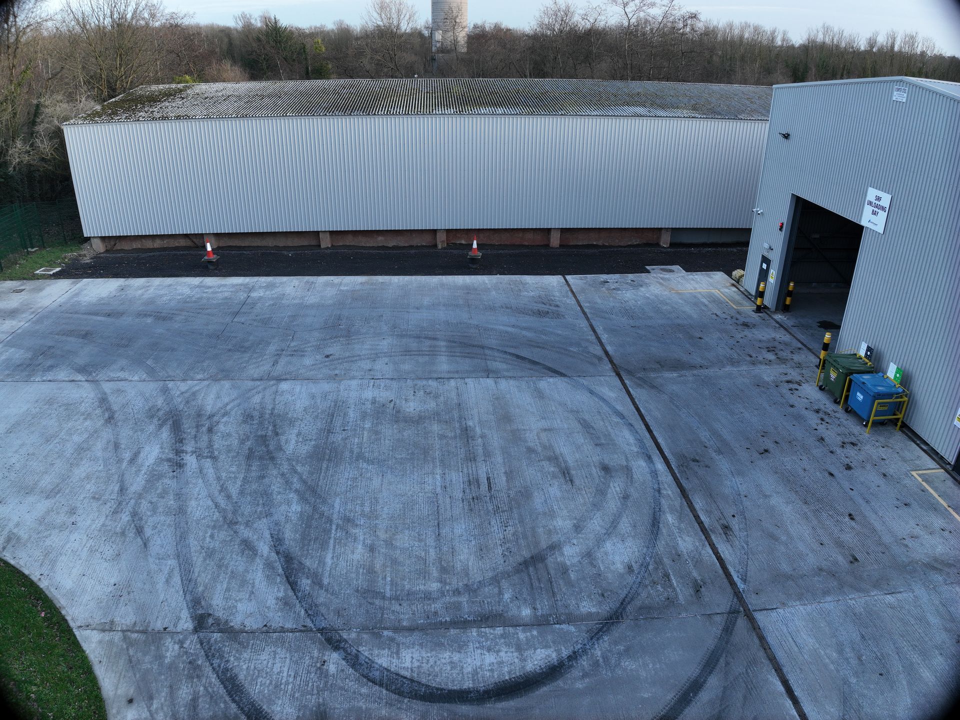 An aerial view of a building with a smiley face drawn on the ground