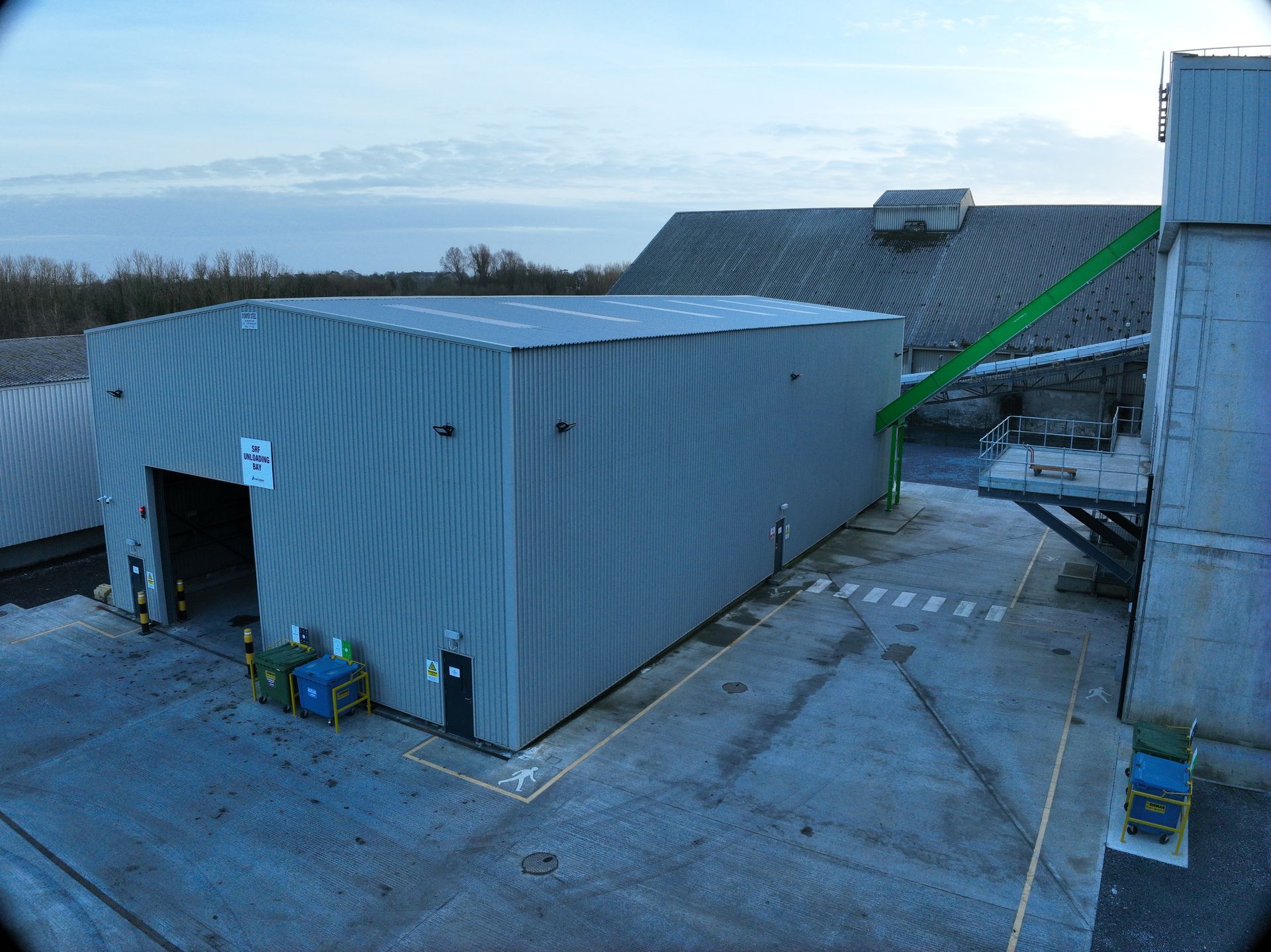 An aerial view of a large building with an arrow pointing to the right