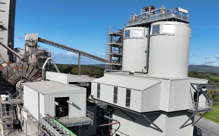 An aerial view of a factory with a blue sky in the background