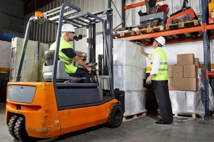 Two men working with a forklift