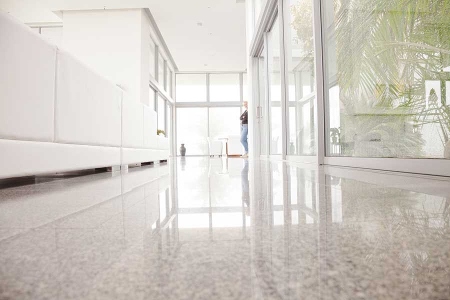 A person is standing in a hallway with a sliding glass door.