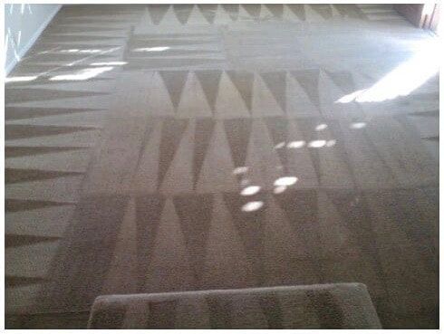 A carpeted floor with a pattern of triangles on it