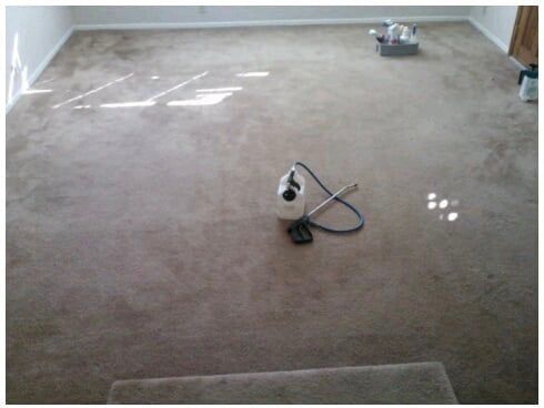 A vacuum cleaner is sitting on the floor of a living room