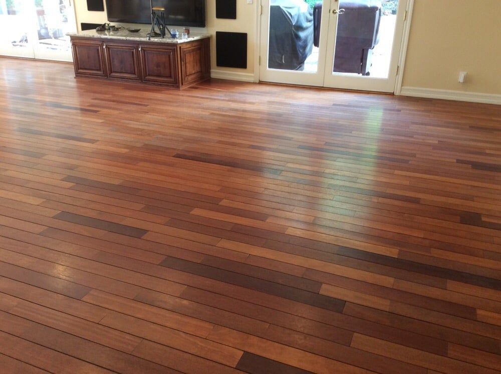A living room with hardwood floors and a television