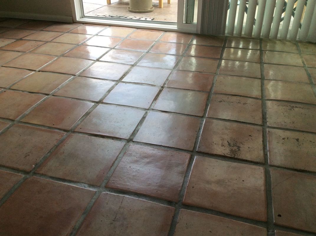 A room with a tiled floor and a sliding glass door