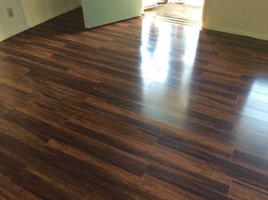 A room with a wooden floor and a door.