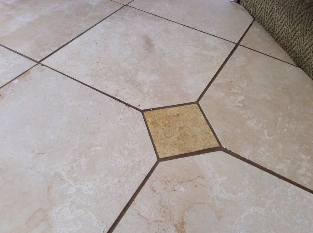 A tiled floor with a square in the middle