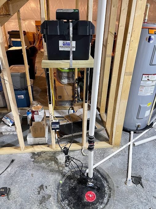 A water heater is sitting in a basement under construction.