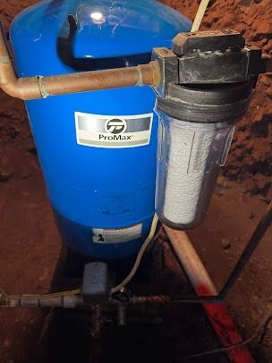 A blue water tank with a filter attached to it.