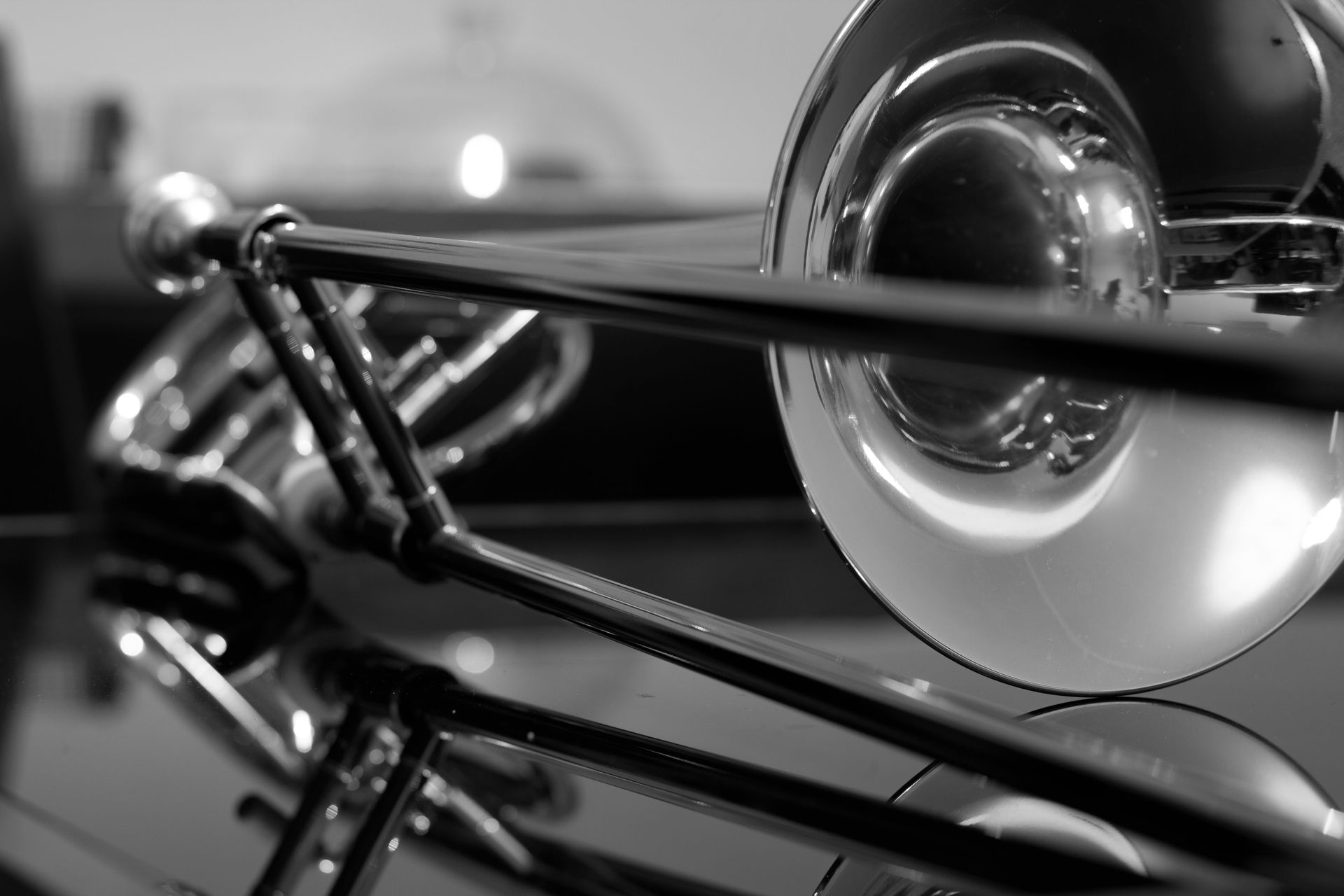 A black and white photo of a trombone on a table
