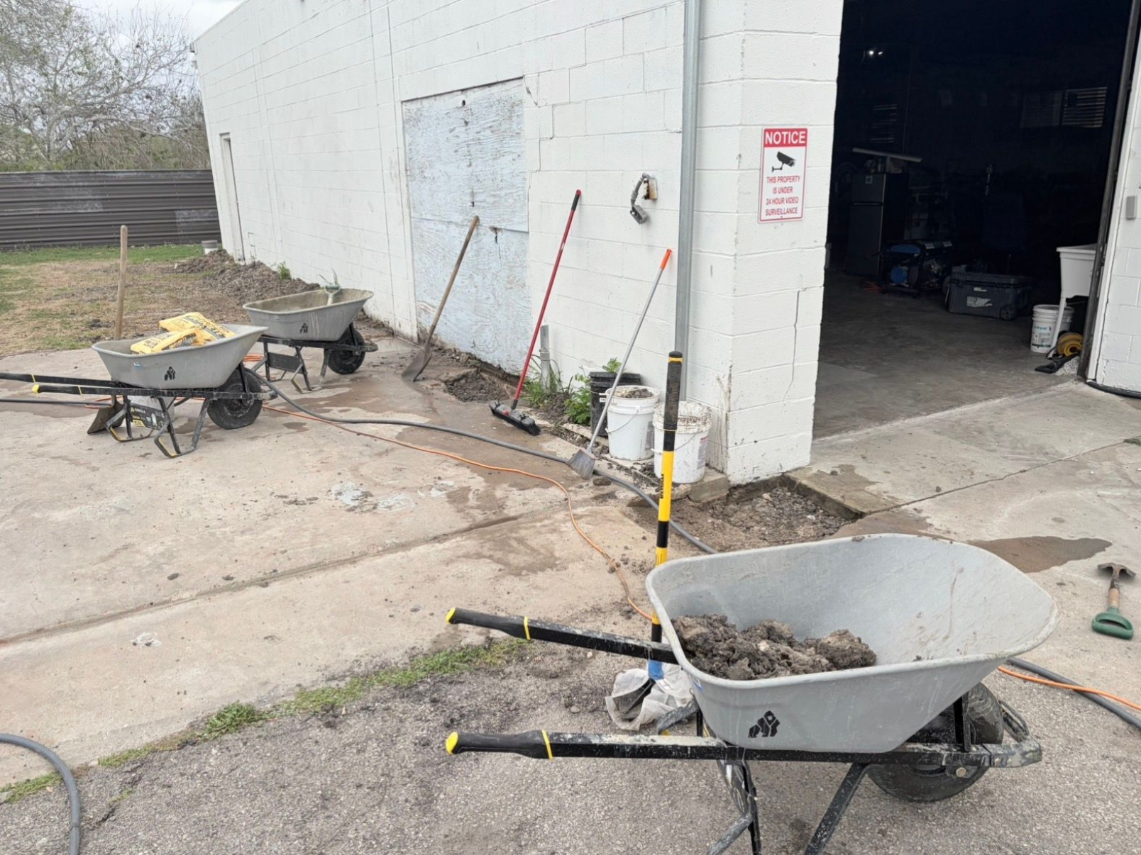 A group of construction workers are pouring concrete on a construction site. - Corpus Christi, TX - Republic of Texas Foundation Repair