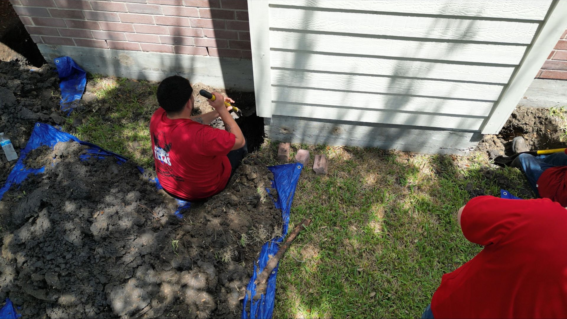 A house that is being built with a man standing in front of it - Corpus Christi, TX - Republic of Texas Foundation Repair