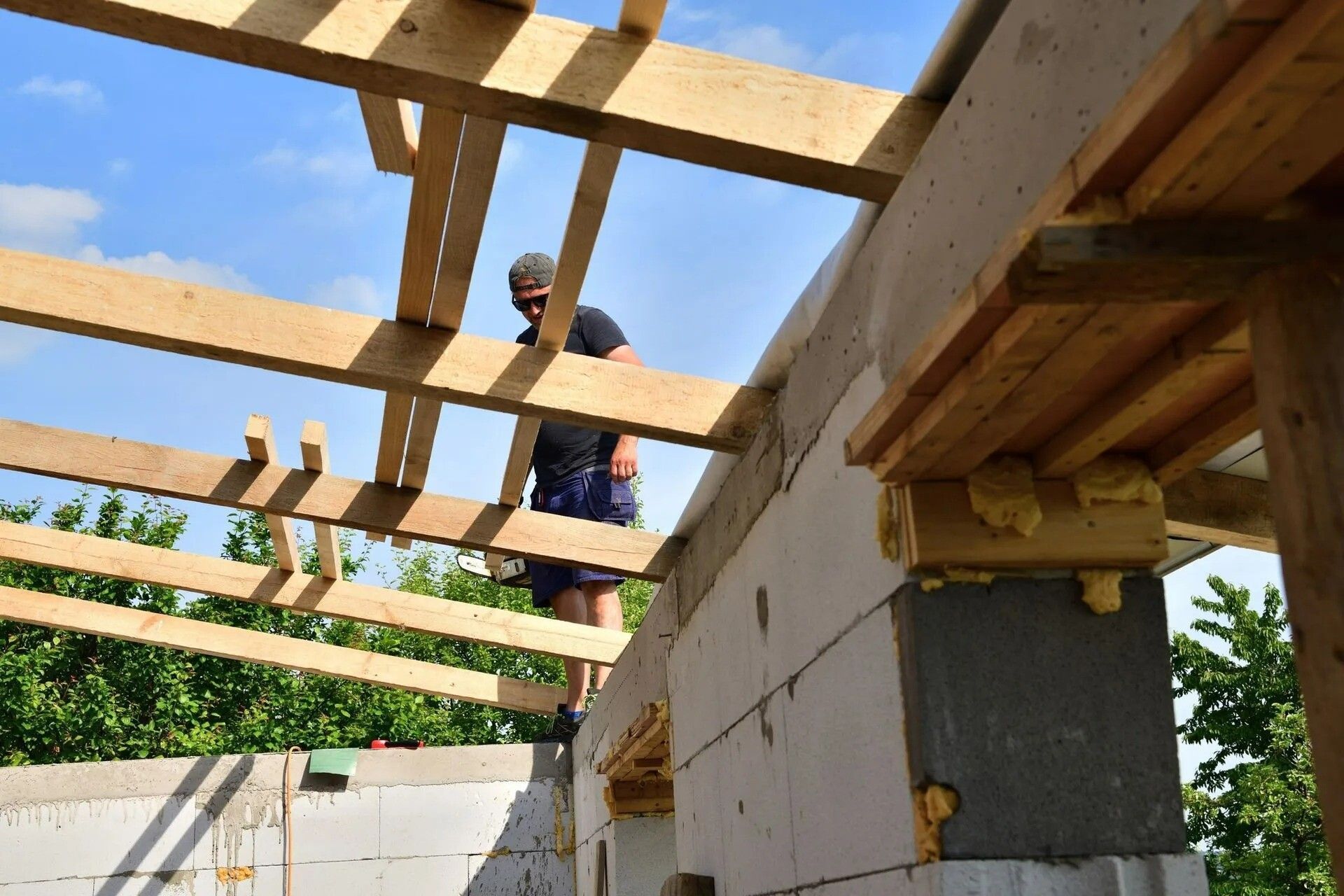 A man is standing on top of a wooden structure. Corpus Christi, TX - Republic of Texas Foundation Repair