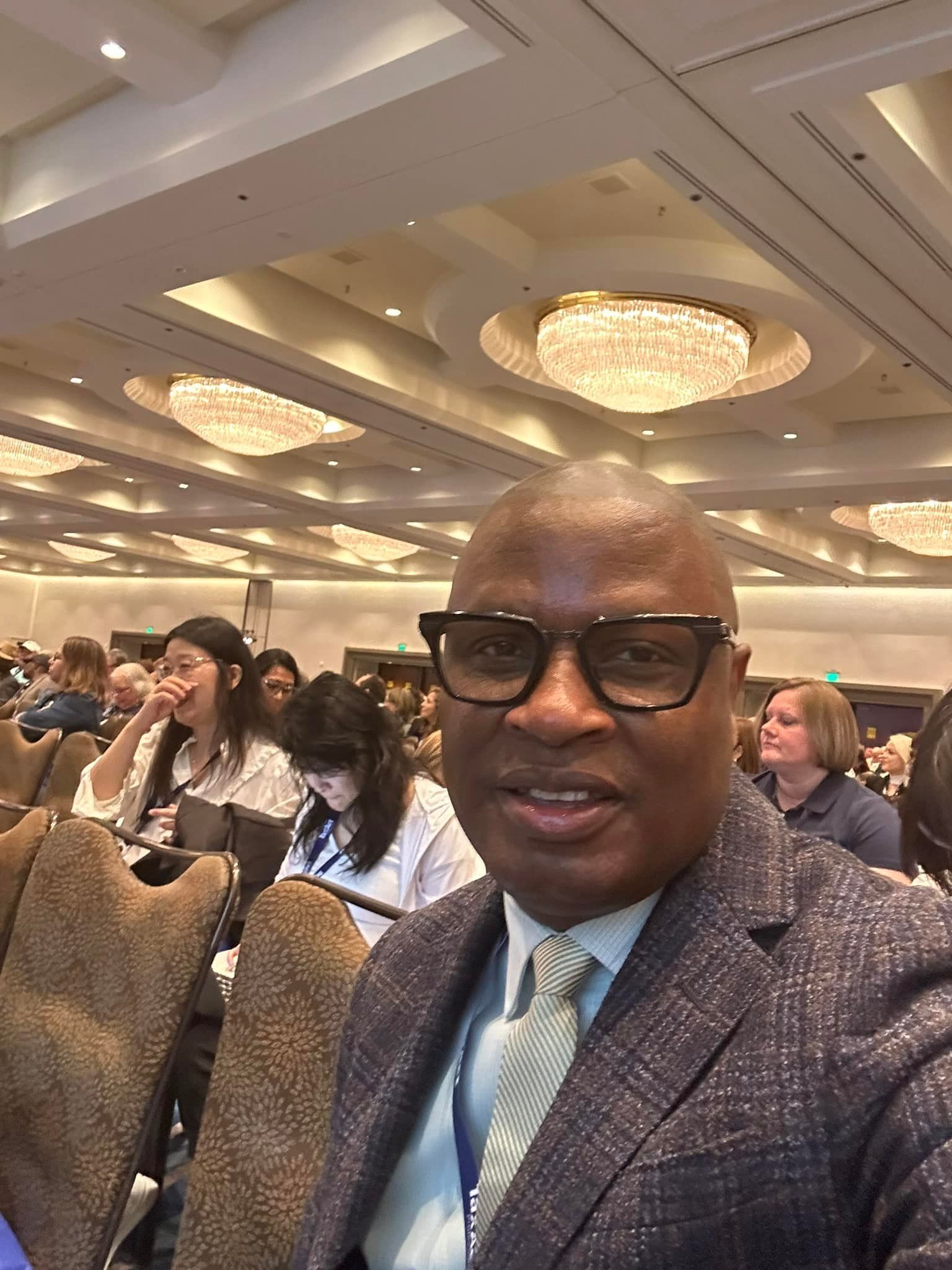 A man is holding a tablet and a scanner in a warehouse.