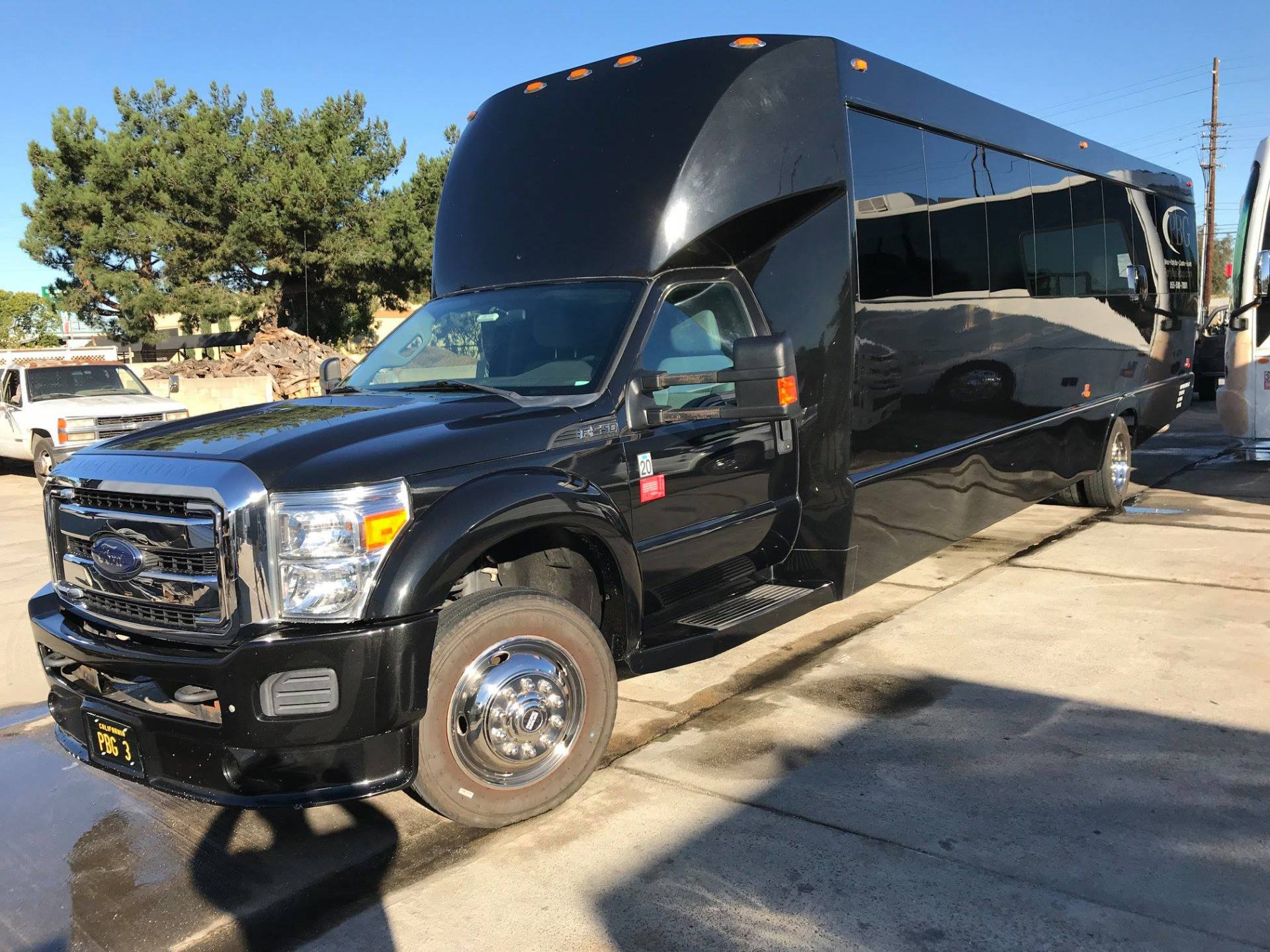 A large black truck is parked in a parking lot.
