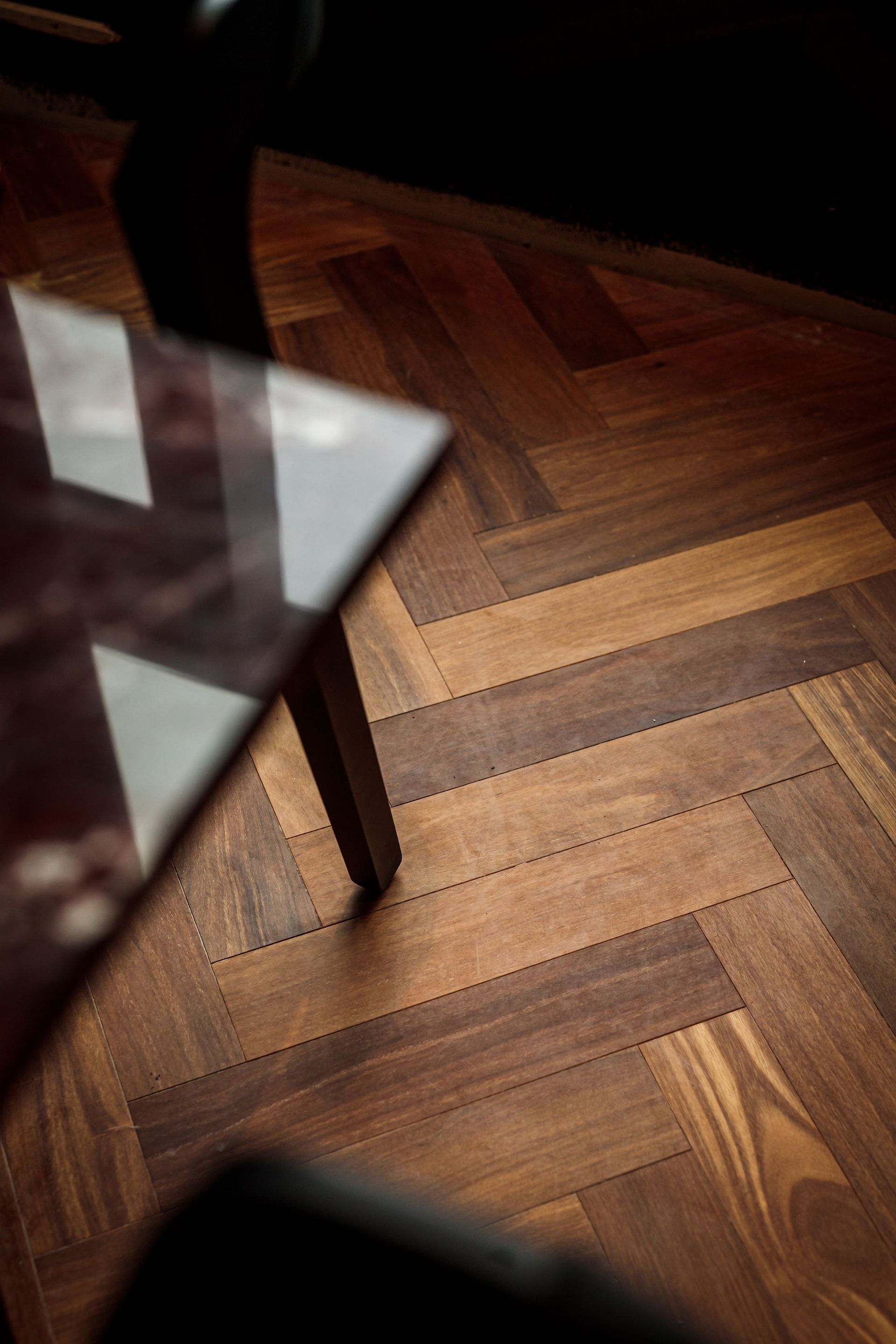 Herringbone wood floor and table leg.