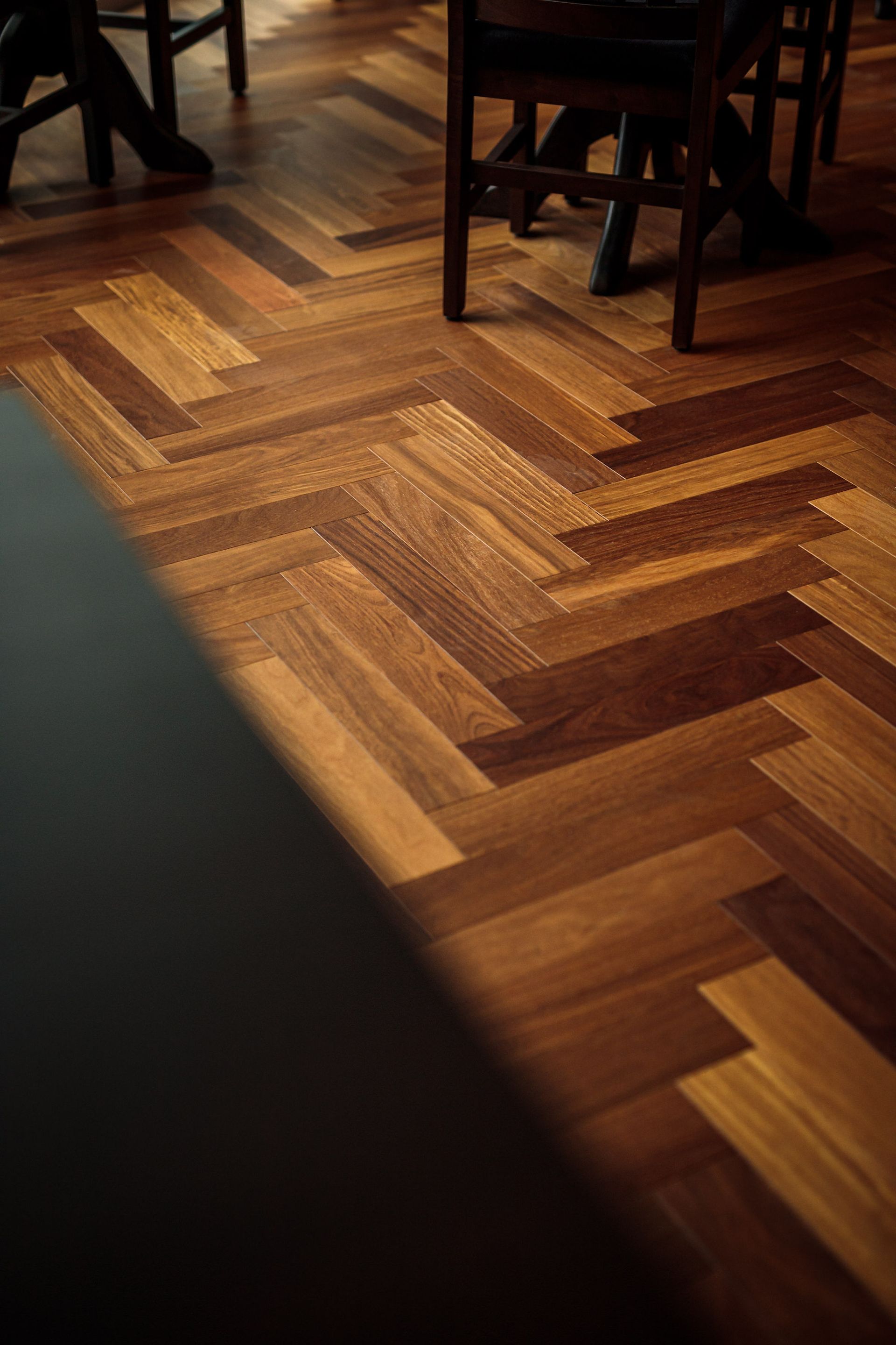 Herringbone pattern wooden floor with chairs.