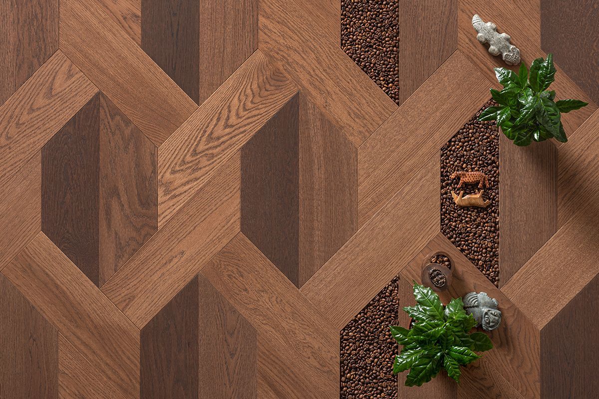 Sol en bois à motifs géométriques avec plantes décoratives et pierres.