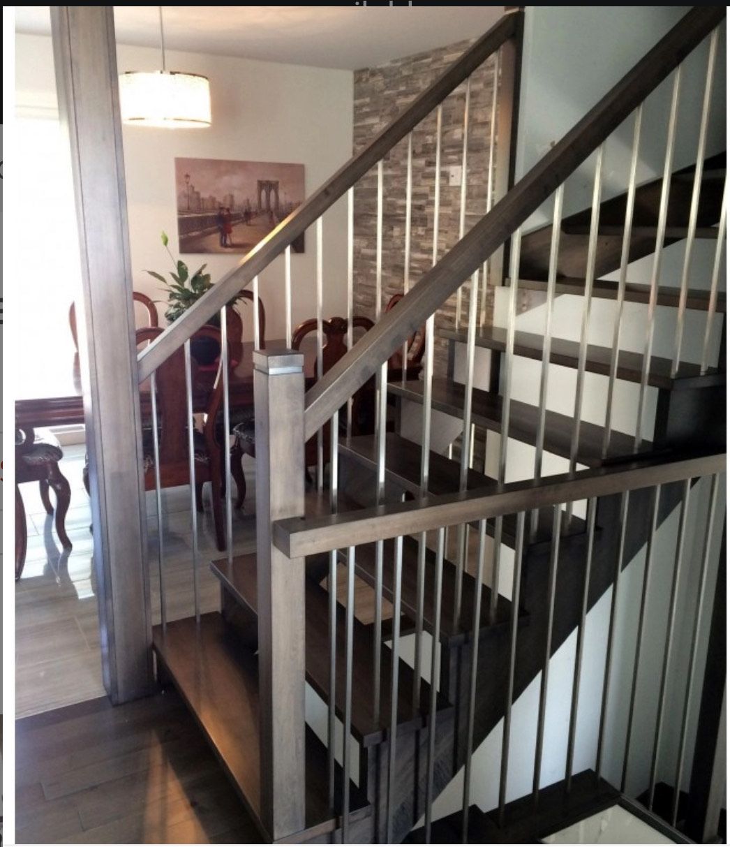Wooden staircase with metal railings inside a home.