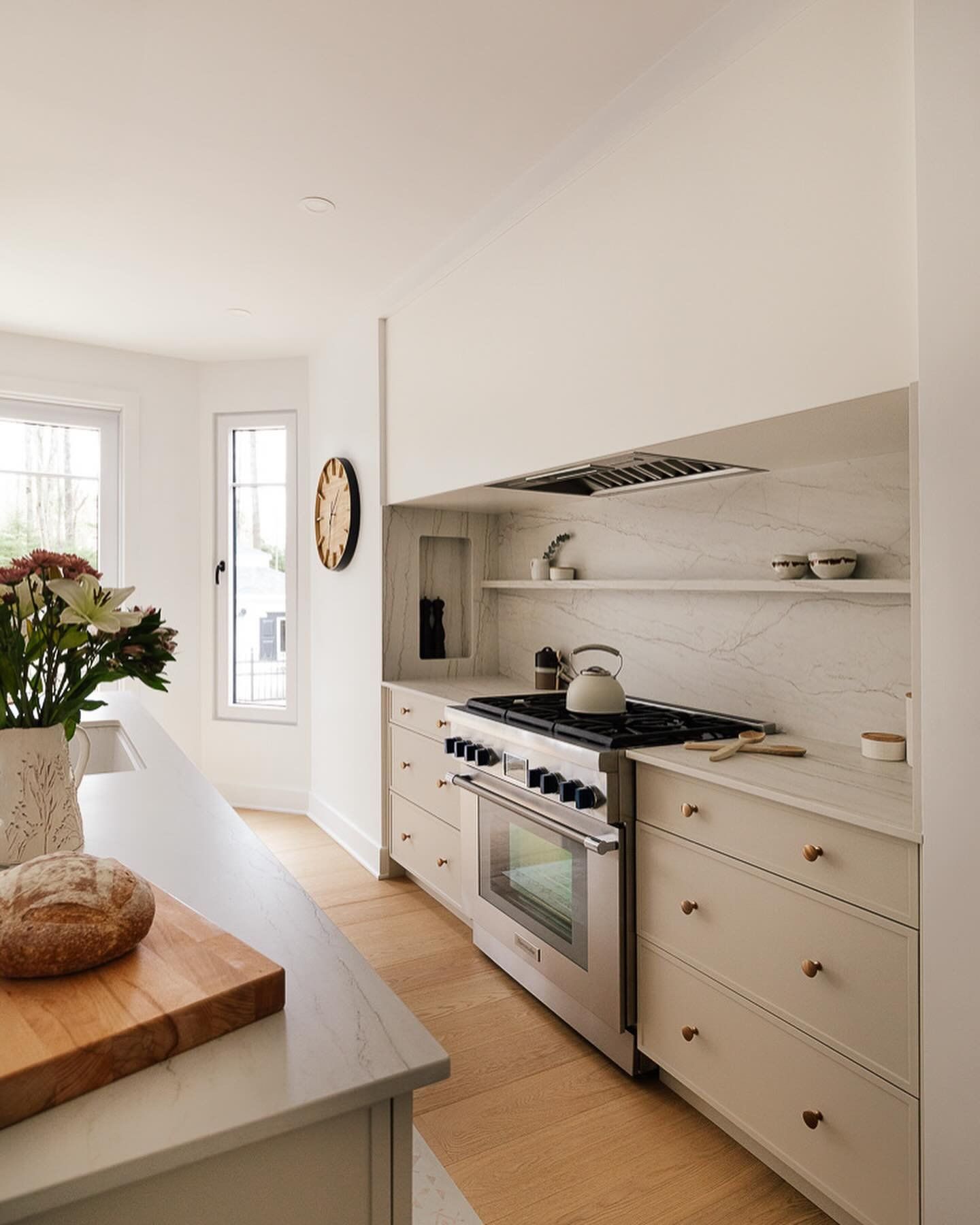 A kitchen with stainless steel appliances and white cabinets