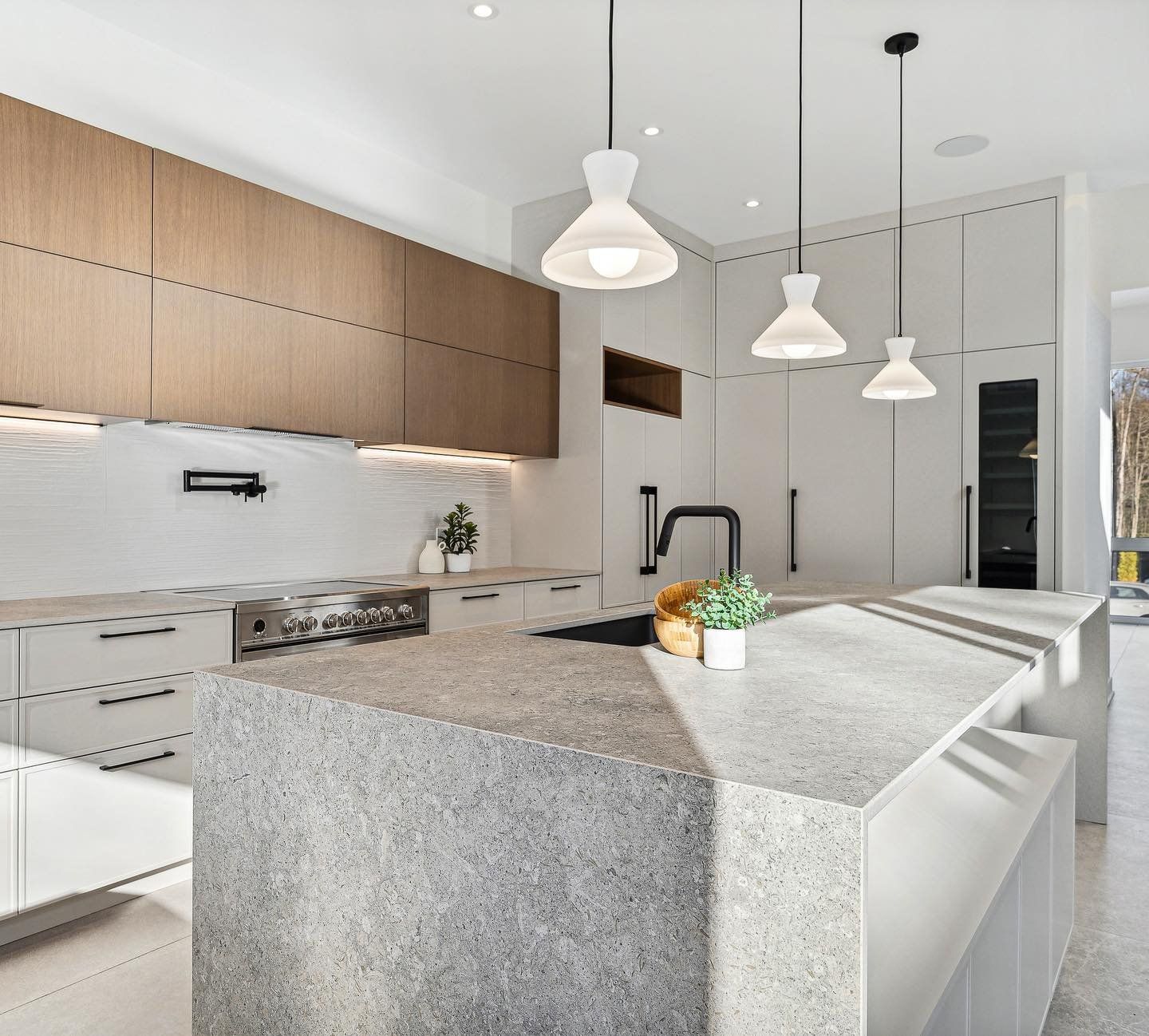 A kitchen with granite counter tops and wooden cabinets