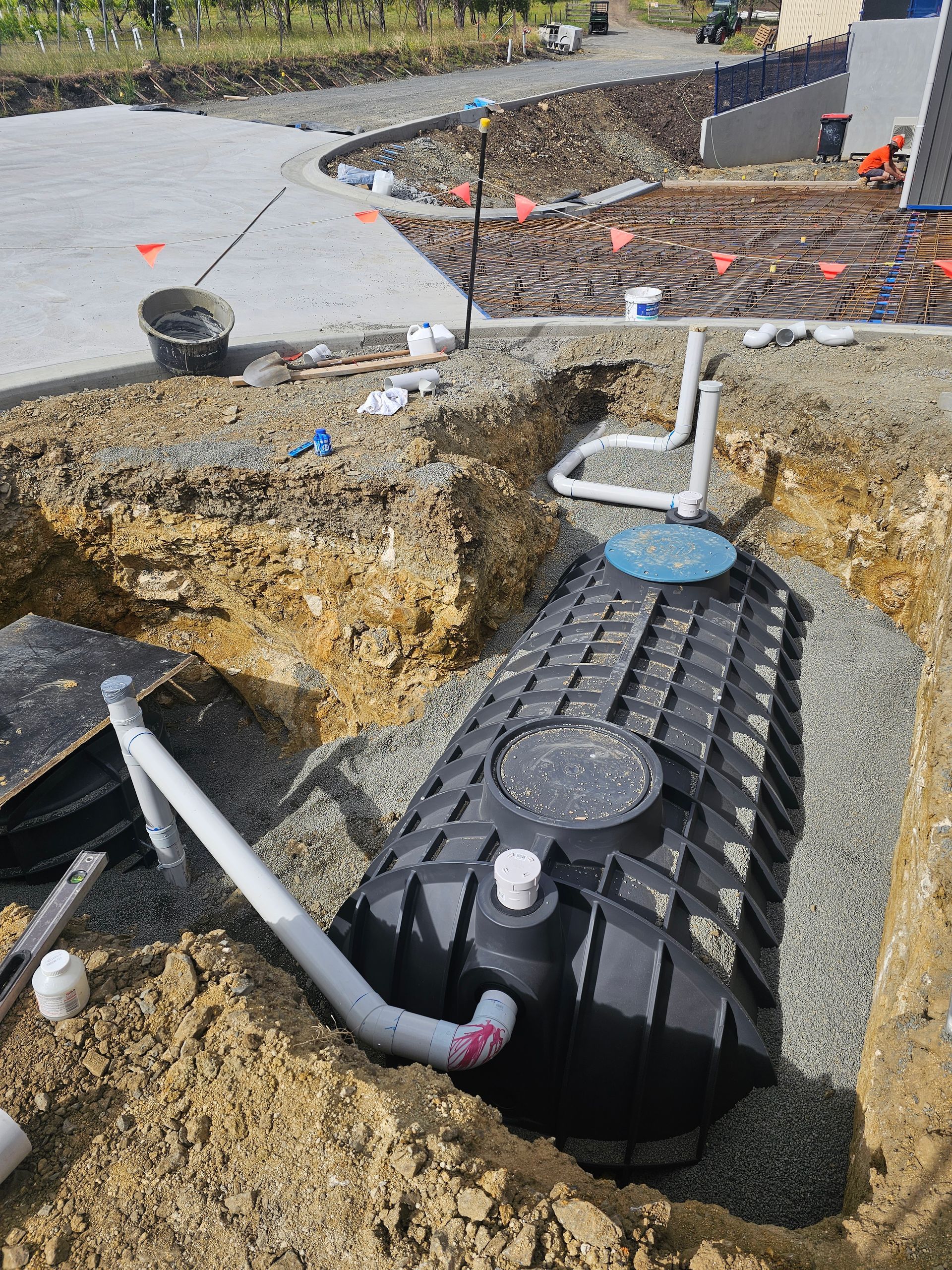 Two Black Plastic Septic Tanks With Green Lids Installed — Lenny's Plumbing & Contracting in Granton, TAS