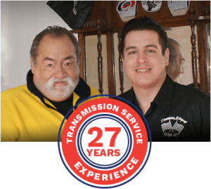 Two men standing next to each other with a transmission service 27 years experience logo