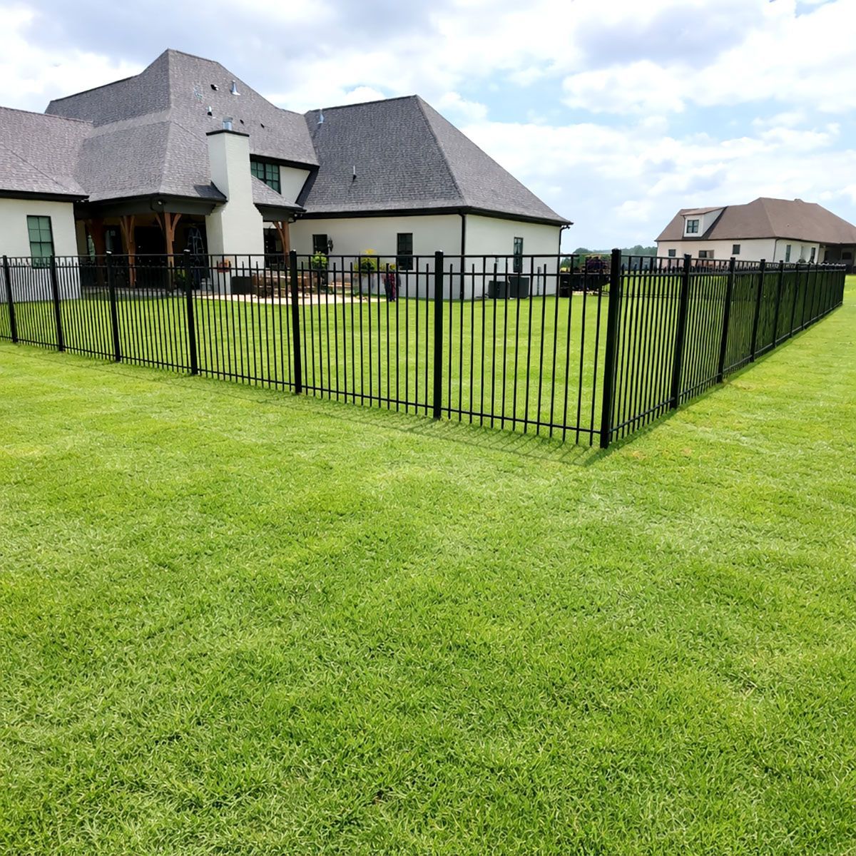 A black metal fence on a white background.