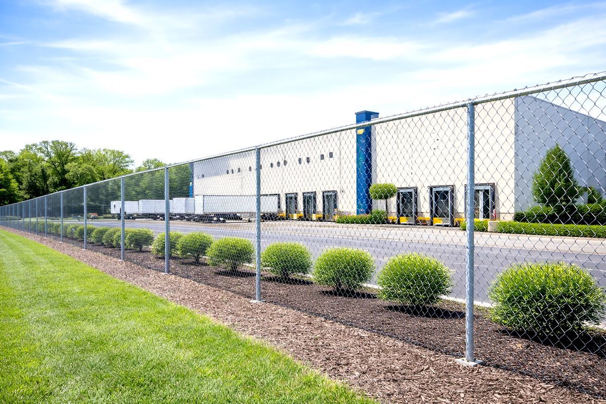 A chain link fence with a gate on a white background.
