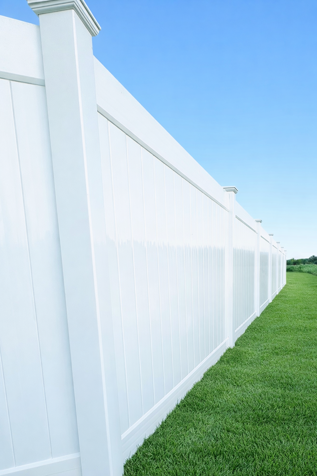 A white vinyl fence with a square post on a white background.