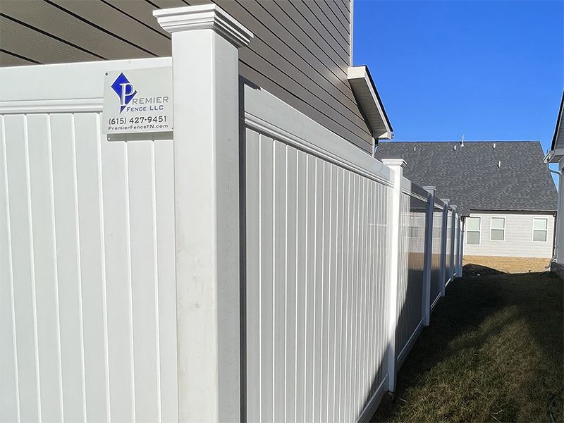 A white fence with a sign that says true on it