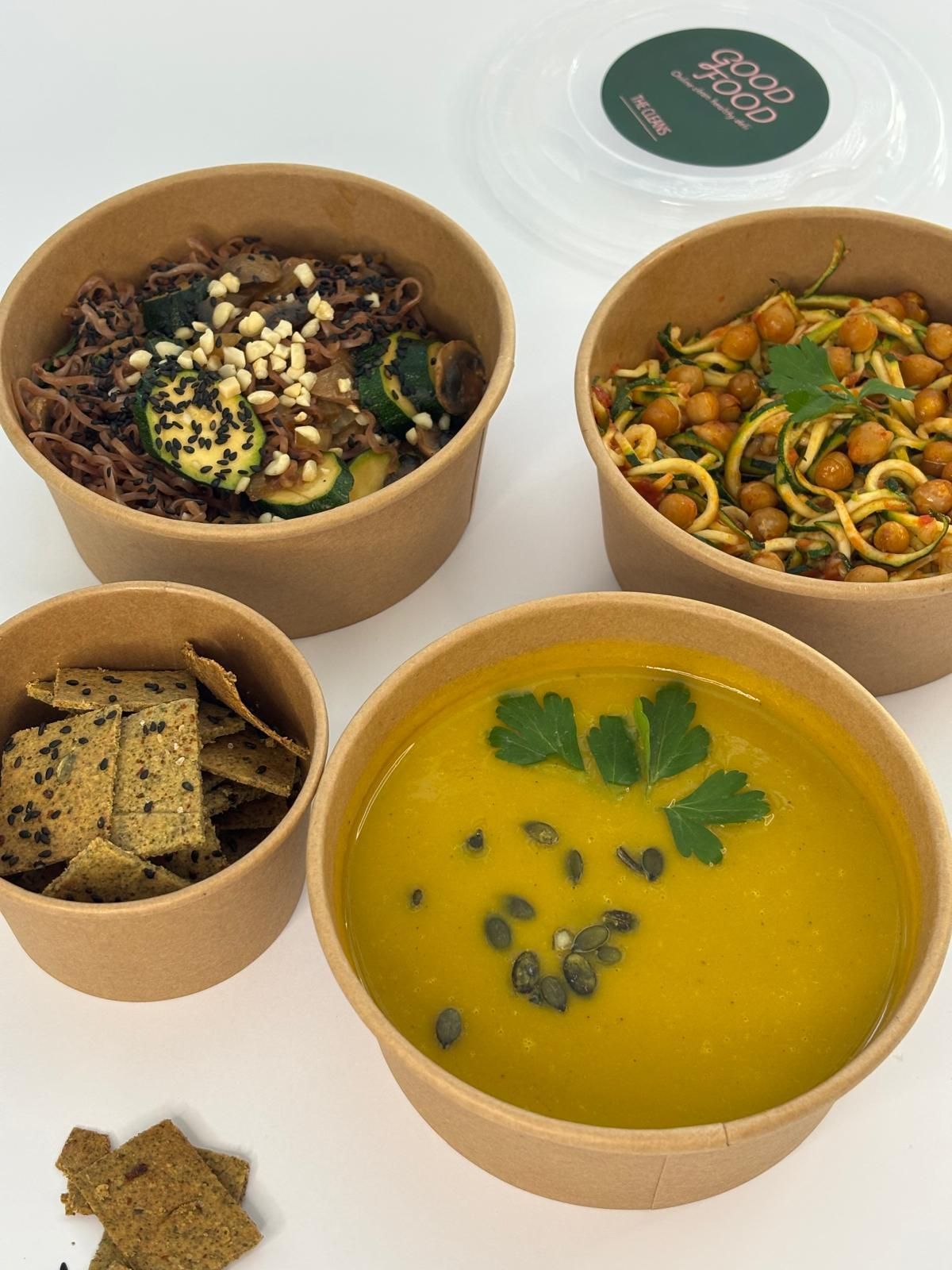 ארבע קערות אוכל יושבות זו ליד זו על שולחן.