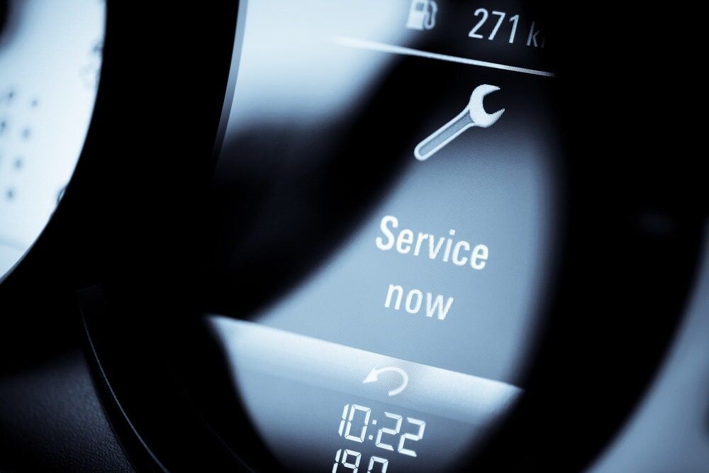 A Close Up of a Car Dashboard Screen That Says Service Now — PT AUTO In Cardiff, NSW