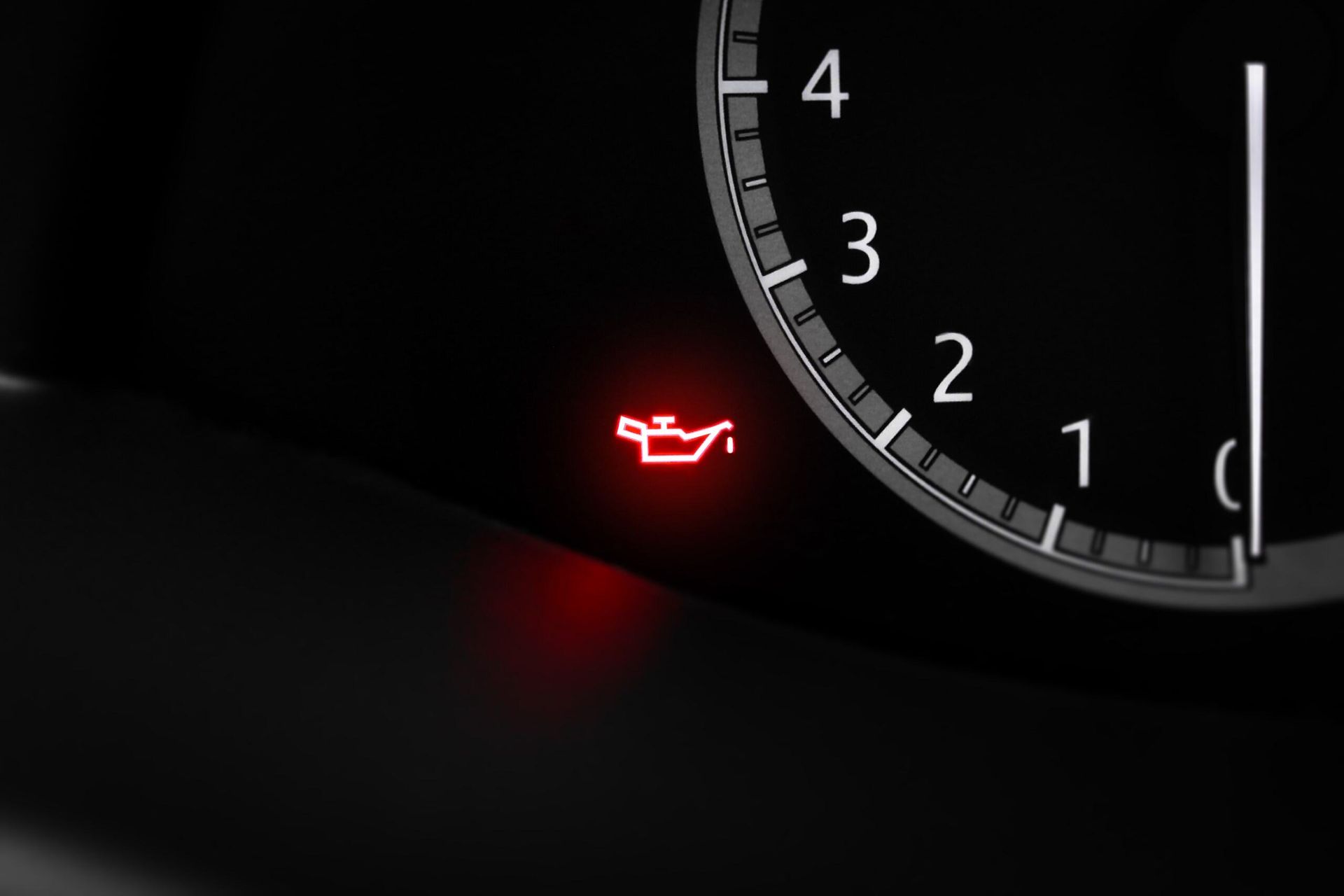 A Close Up of a Car 's Oil Pressure Gauge With a Red Light on It — PT AUTO In Cardiff, NSW