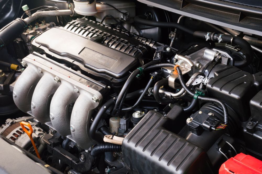 A Close Up of a Car Engine With the Hood Open — PT AUTO In Cardiff, NSW
