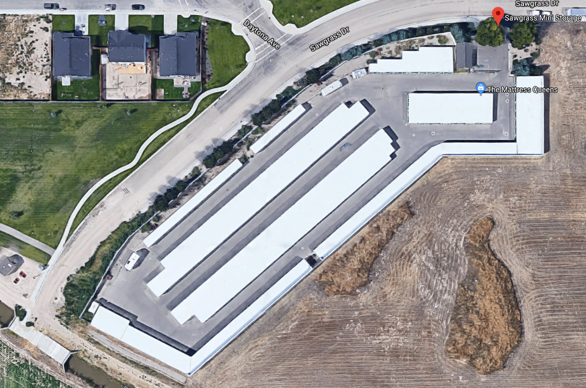 An aerial view of a parking lot with lots of white buildings