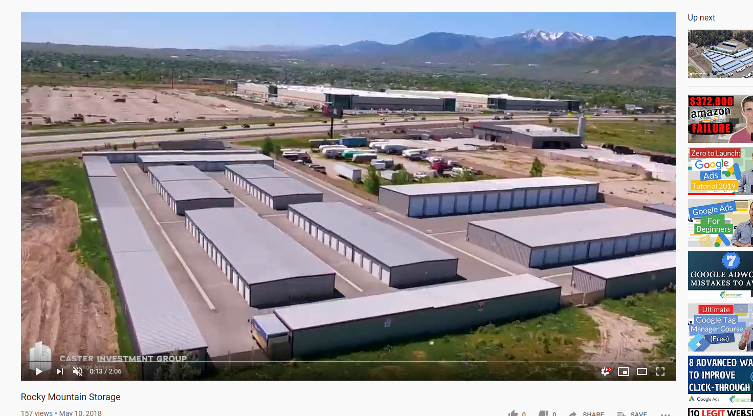 An aerial view of a storage facility with mountains in the background