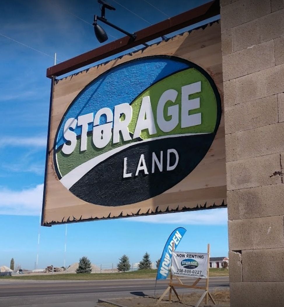 A sign for storage land hangs from the side of a building