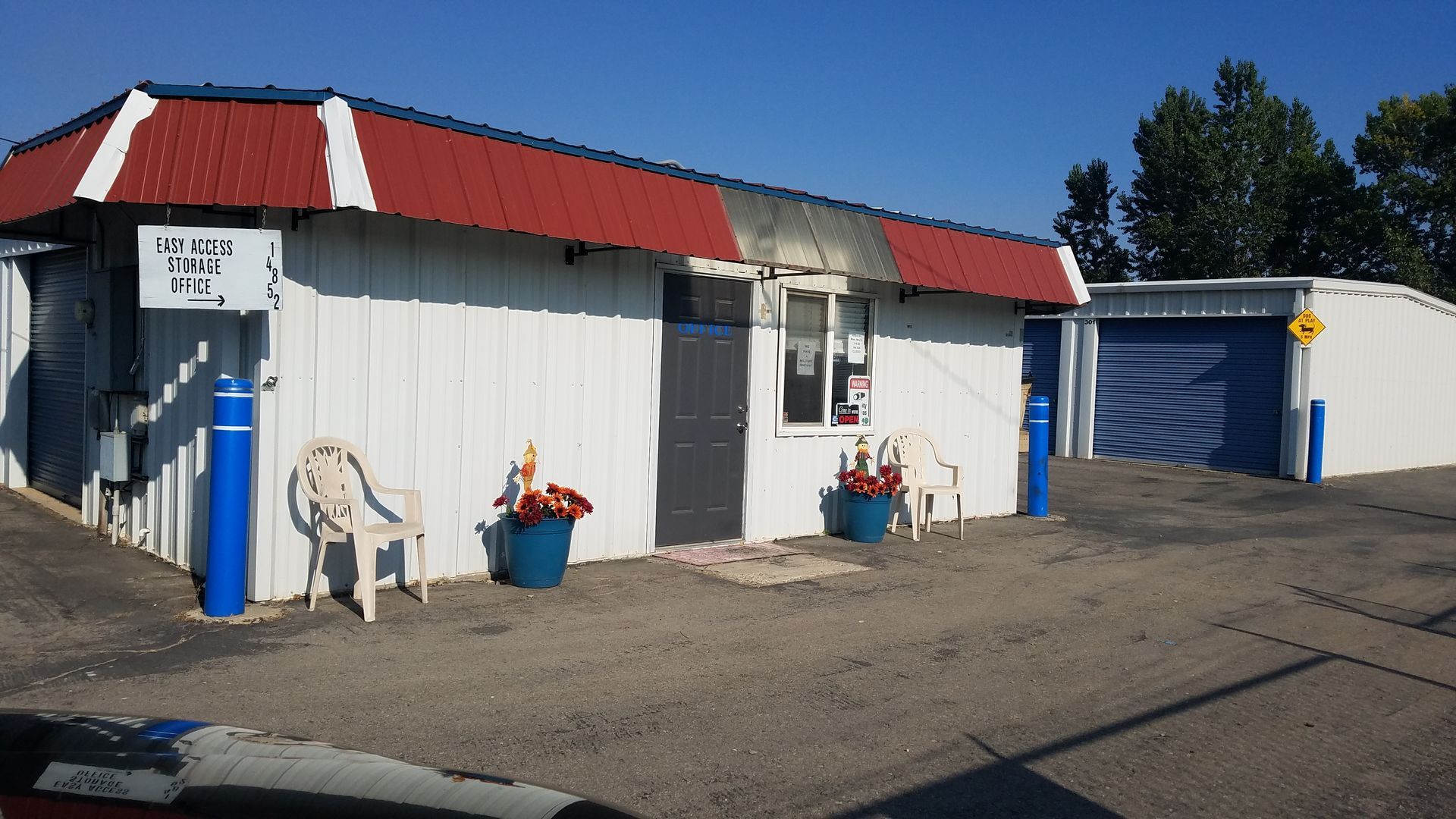 A white building with a red roof and a sign that says ' a ' on it