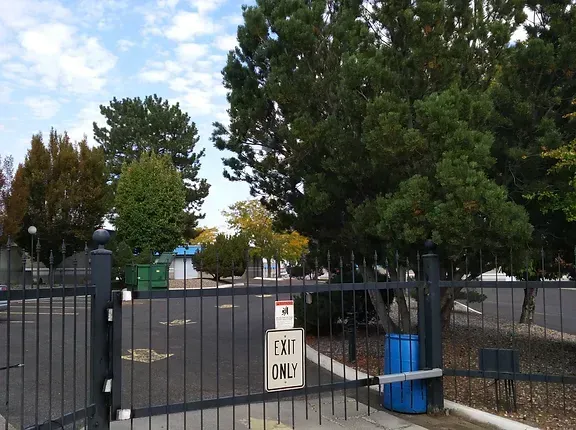 A fence with a sign that says exit only
