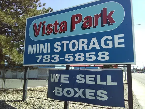 A sign for vista park mini storage and we sell boxes
