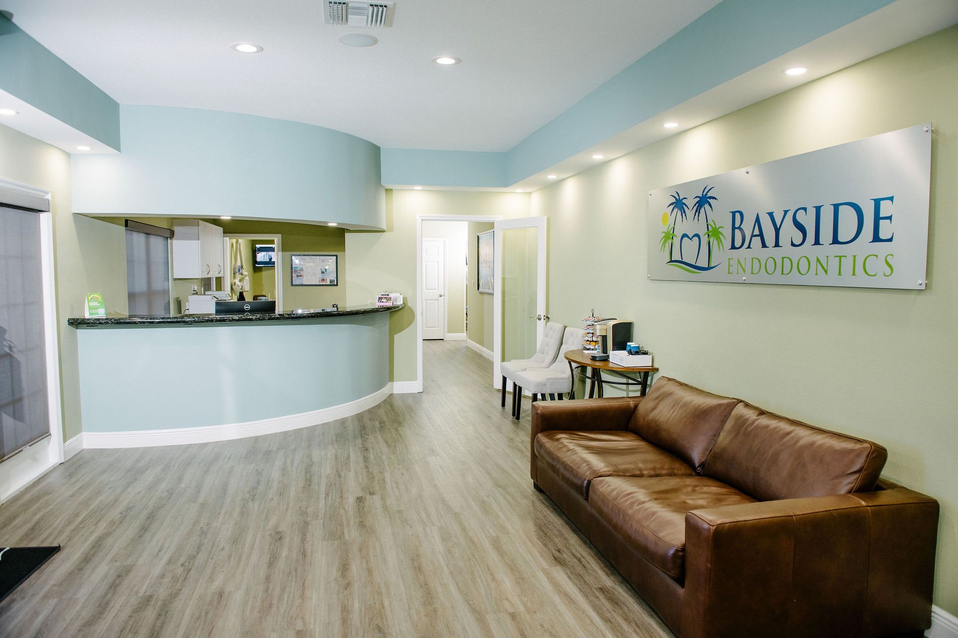 A dental office with a couch and a counter.