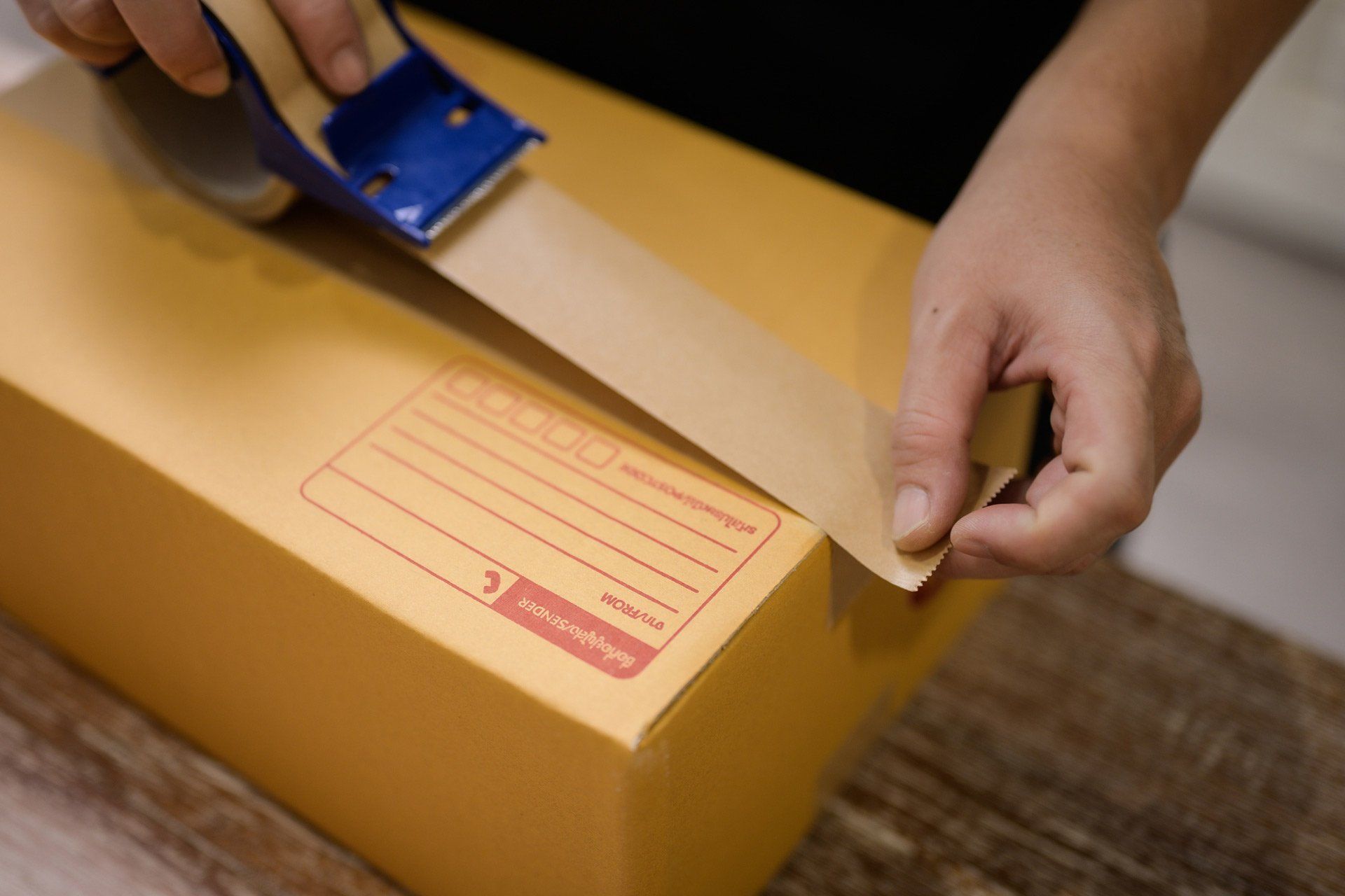 Cardboard Box Package Getting Sealed with Brown Tape | Springwood, Nsw | Springwood Removals