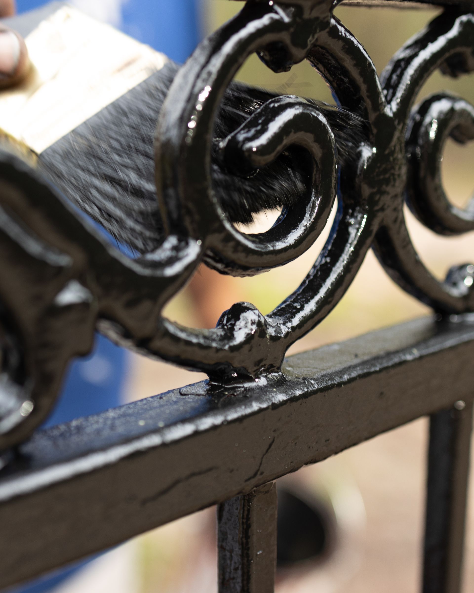 A close up of a black wrought iron fence