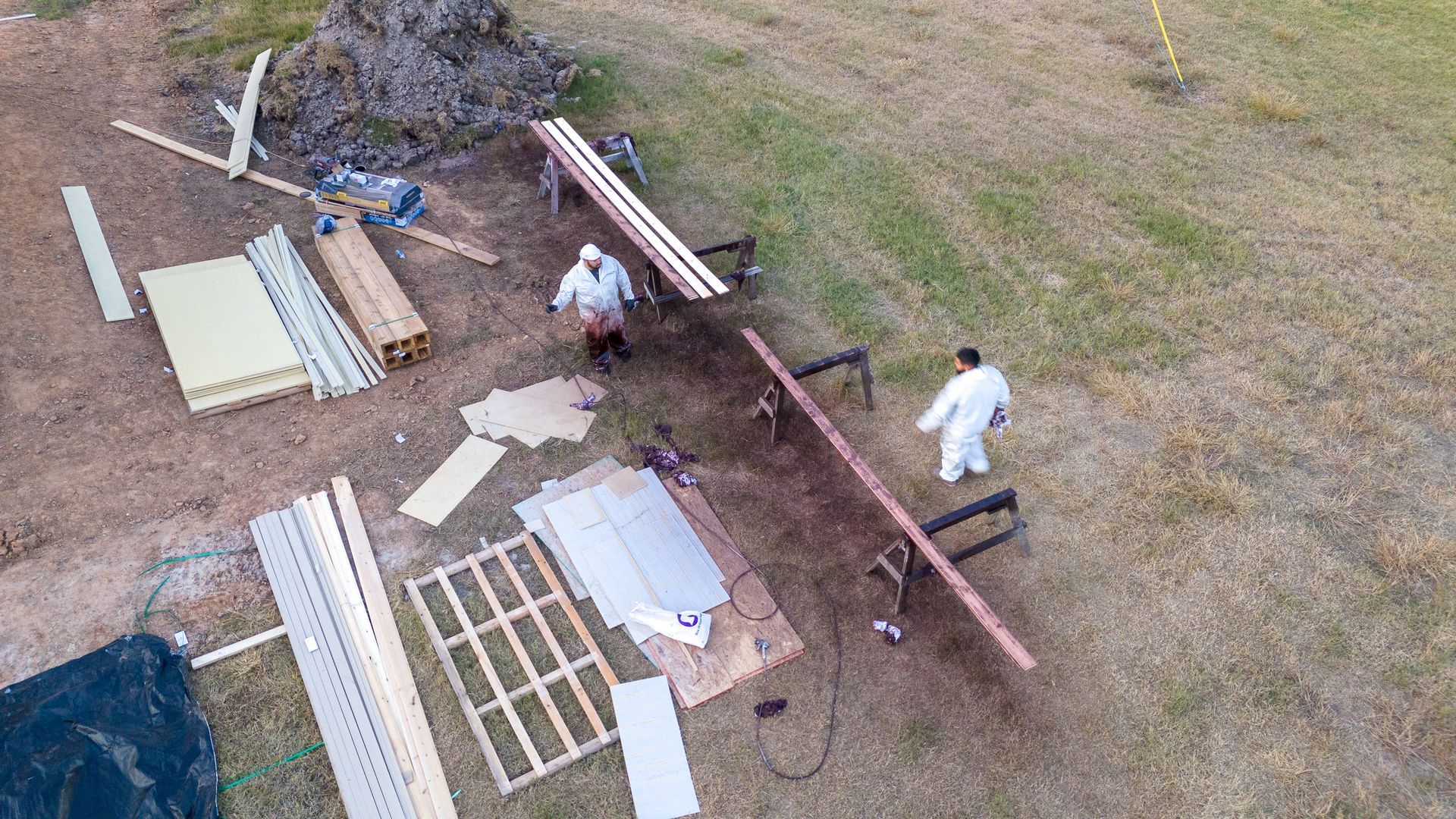 An aerial view of a group of people working on a wooden structure.
