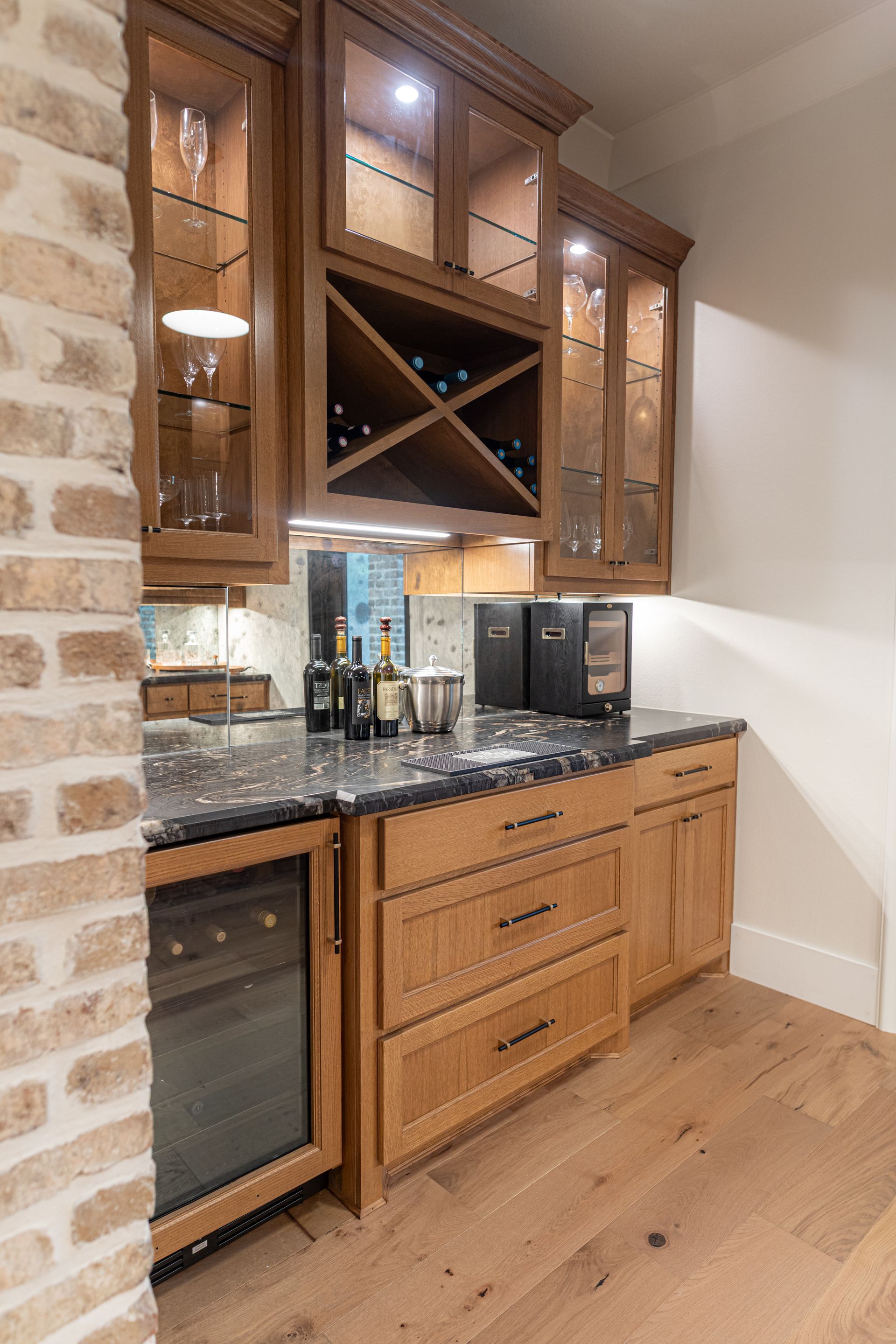 A kitchen with white cabinets and wooden stools