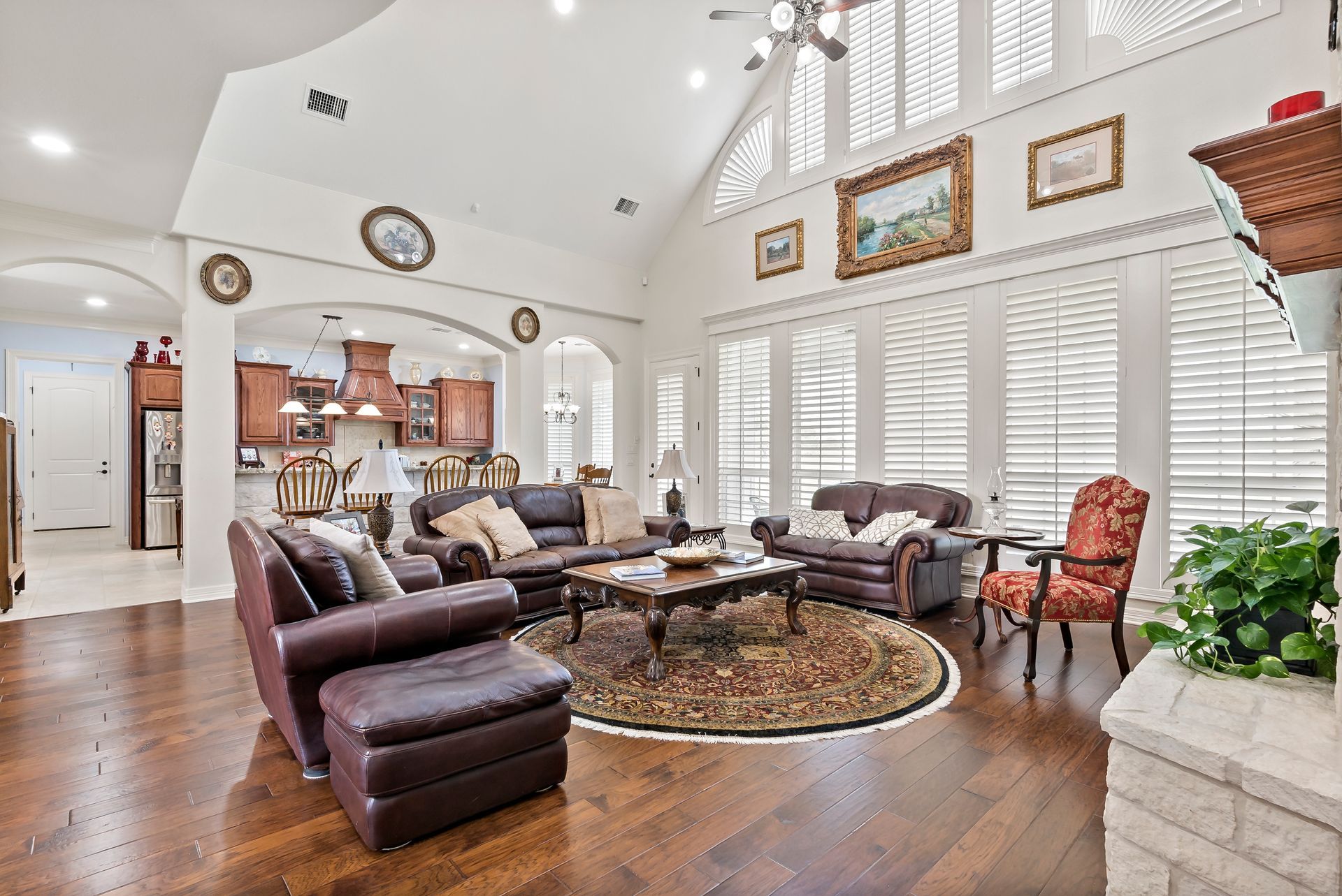 A living room filled with furniture and a ceiling fan.